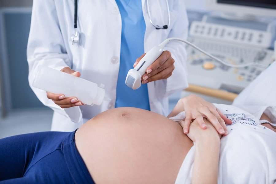 Pregnant woman receiving an ultrasound examination during prenatal care