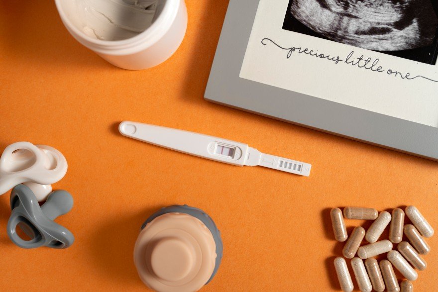 Positive pregnancy test with ultrasound image and prenatal supplements